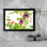 Infidu Vintage Floral Wall Art with deep purple and soft pink flowers, green leaves, and a black frame on a white background. displayed on the wall