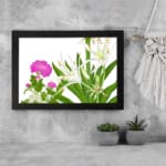 Infidu vintage wall art with delicate white and pink flowers, green leaves, and a black frame on a white background for a timeless botanical look. displayed on the wall art in a black frame