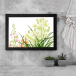 Infidu vintage wall art with green, pink, white, and orange flowers, lush leaves, and a black frame on a white background for a timeless look. displayed on the wall art in a black frame