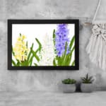 Infidu vintage wall art with yellow, white, and purple flowers, green leaves, and a black frame on a white background for a timeless botanical look. displayed on the wall art in a black frame