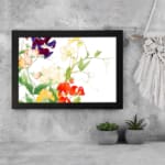 Infidu vintage wall art with red, yellow, purple, and white flowers, green leaves, and a black frame on a white background for an elegant look. displayed on the wall