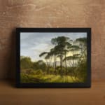 Vintage wall art of a serene forest with sunlight streaming through trees and distant hills in the background. displayed on the wall in a black frame