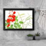 Infidu vintage wall art with bright red flowers and green leaves, set against a white background and framed in black for a classic and elegant look. displayed on the wall