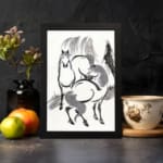 Infidu vintage wall art featuring two horses in black and white ink with bold brushstrokes, creating a timeless and dynamic design. displayed on the wall art in a black frame