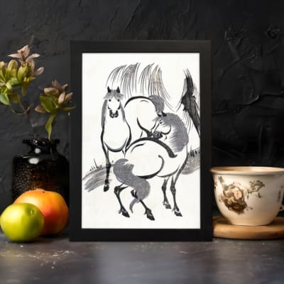 Infidu vintage wall art featuring two horses in black and white ink with bold brushstrokes, creating a timeless and dynamic design. displayed on the wall art in a black frame