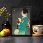 Infidu vintage wall art featuring a traditional Japanese woman in a teal kimono with intricate patterns, holding a fan and a small box, gazing at a glowing object against a muted gray background. displayed on the wall art in a black frame