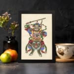 Infidu vintage wall art featuring a Chinese warrior in vibrant red, green, blue, and gold attire, standing atop a fierce mythical beast while wielding a staff, set against an off-white background. displayed on the wall art in a black frame