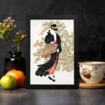 Vintage wall art of a Japanese woman in a black kimono holding a fan, with delicate trees in the background. displayed on the wall in a black frame