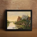 Dreamy vintage river landscape with deer, two castles, and a golden sky in a peaceful fairytale setting. displayed on the wall in a black frame