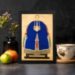 Vintage wall art of a classic East Asian portrait showing a person in a royal blue robe with gold accents on a beige background. displayed on the wall in a black frame
