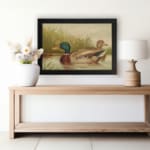 Vintage wall art of a peaceful duck pond scene with two ducks swimming, tall grass in the background, and soft earthy tones for a classic look. displayed on the wall