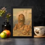 Vintage wall art of a majestic lion family in a natural setting with warm earthy tones, including a lion, lioness, and cubs in a savannah backdrop. displayed on the wall in a black frame