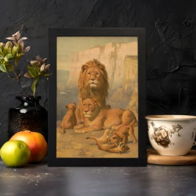 Vintage wall art of a majestic lion family in a natural setting with warm earthy tones, including a lion, lioness, and cubs in a savannah backdrop. displayed on the wall in a black frame