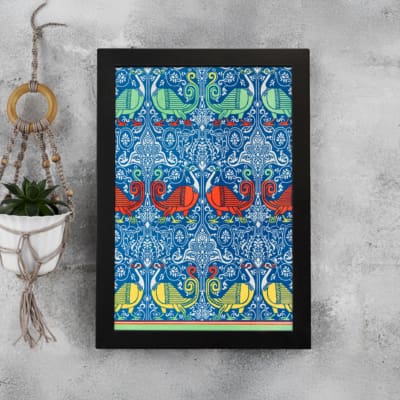 Vintage wall art with intricate decorative patterns in blue, red, green, and yellow, set against a blue background with a black frame. displayed on the wall