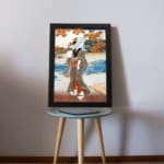 Vintage Japanese wall art with a woman in a kimono near a river, detailed autumn leaves, and a serene landscape in classic Ukiyo-e style. displayed on the table
