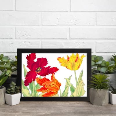Vintage floral wall art with red, orange, and yellow tulips, green leaves, and a black frame on a white background. displayed on the wall