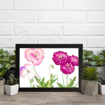 Vintage floral wall art featuring pink and purple flowers with green leaves, set against a white background with a black frame. displayed on the wall