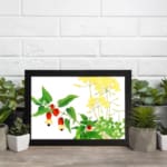 Vintage floral wall art featuring red and yellow flowers with green leaves on a white background, framed in black for a classic and elegant look. displayed on the wall