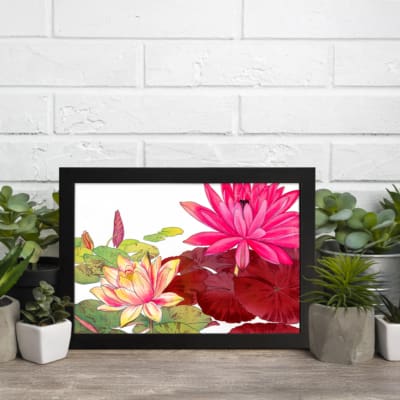 Vintage floral wall art featuring pink, red, and yellow lotus flowers with green leaves on a white background, framed in black. display on the wall