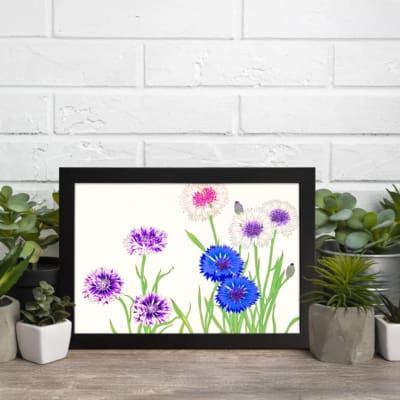 Infidu Vintage Floral Wall Art with blue, purple, and white flowers, green stems, and a black frame on a light background. displayed on the wall