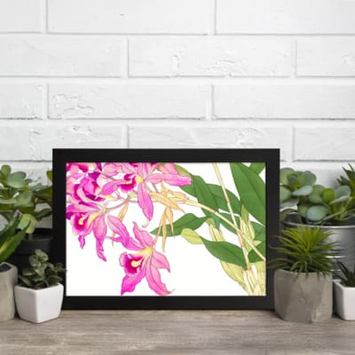 Vintage floral wall art with pink orchids, yellow centers, green leaves, and a black frame on a white background. displayed on the wall