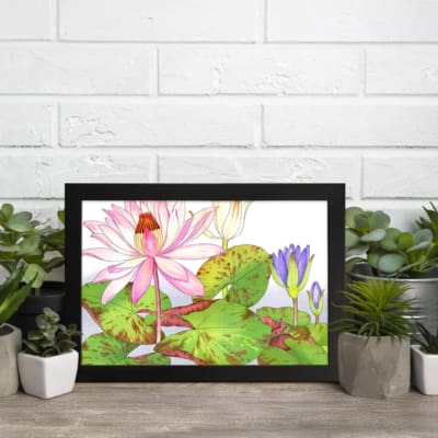 Vintage floral wall art with a pink water lily, purple flowers, and green leaves on a white background, framed in black for a classic look. displayed on the wall