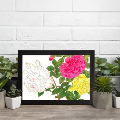 Vintage floral wall art with pink, yellow, and white roses, green leaves, and a black frame on a white background. displayed on the wall