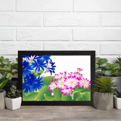 Infidu Vintage Floral Wall Art with deep blue and pink flowers, bright green leaves, a white background, and a black frame for a classic touch. displayed on the wall