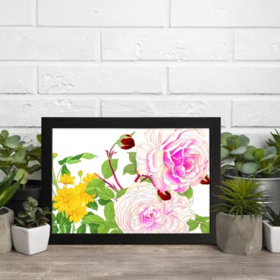 Vintage floral wall art with pink and white roses, red buds, and green leaves in a black frame on a white background. displayed on the wall