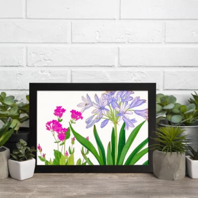 Infidu Vintage Floral Wall Art with soft purple and bright pink flowers, green leaves, a white background, and a black frame for a stylish touch. displayed on the wall