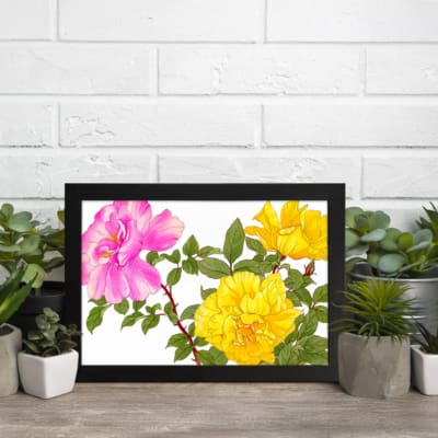 Infidu Vintage Botanical Wall Art with pink and yellow flowers, green leaves, and a black frame on a white background. displayed on the wall