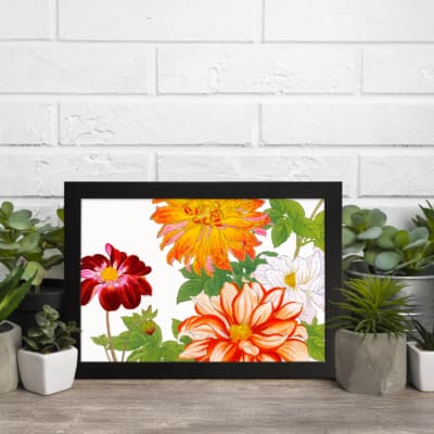 Vintage floral wall art with large orange, red, and white flowers, green leaves, and a black frame on a white background. displayed on the wall