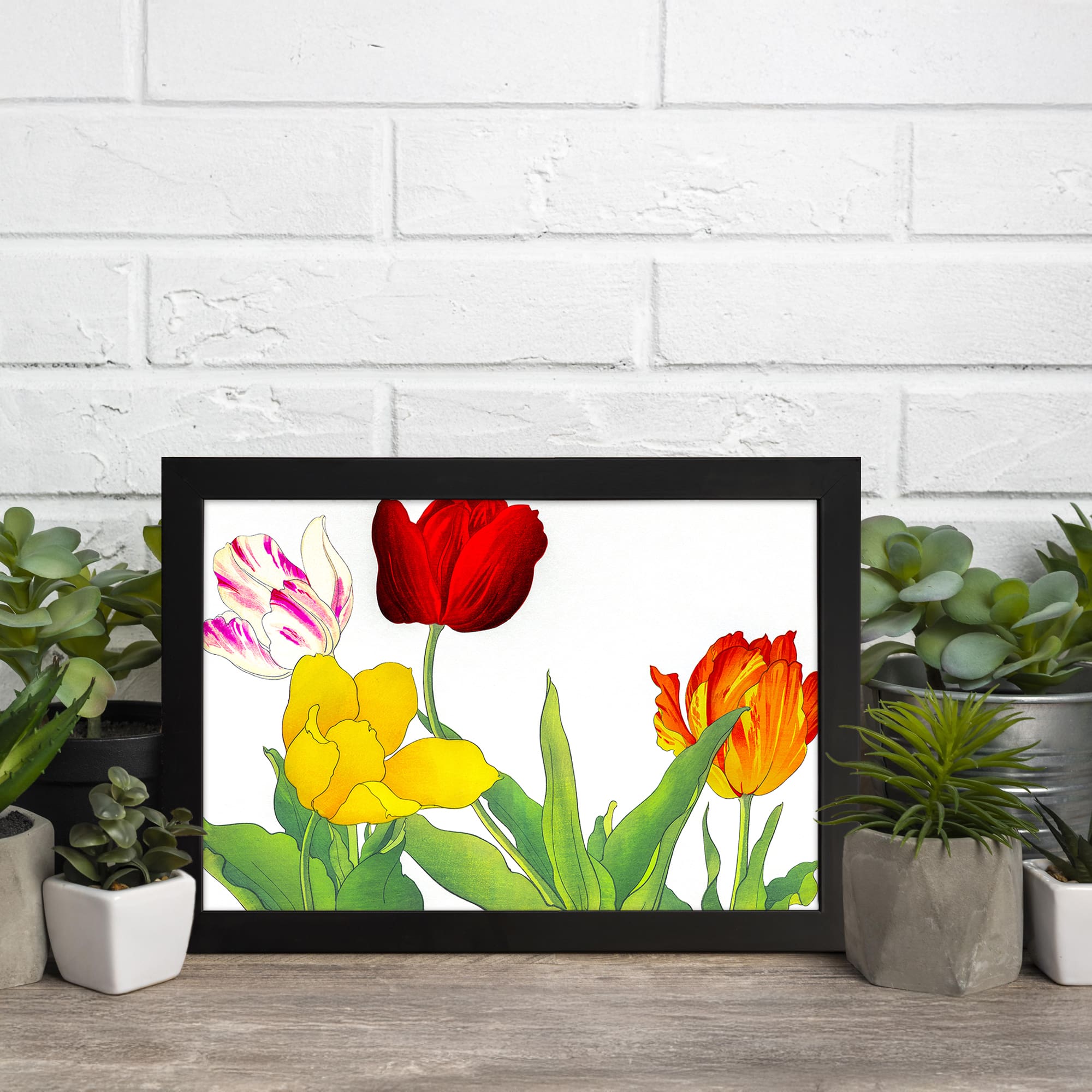 Vintage floral wall art with colorful tulips in red, yellow, orange, and white with pink streaks, surrounded by green leaves and framed in black. displayed on the wall