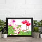 Infidu Vintage Floral Wall Art with pink and red flowers, green leaves, and a white background in a classic vintage design. displayed on the wall in a black frame