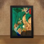 Vintage Asian-style mountain wall art with bold green hills, waterfalls, trees, and traditional red stamp. displayed on the wall in a black frame