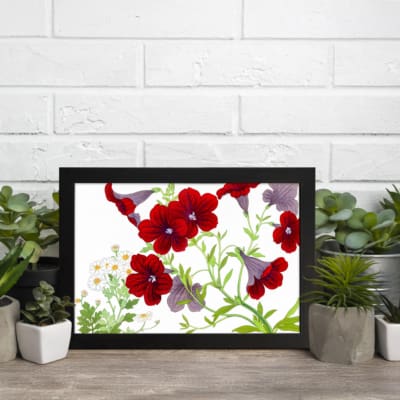 Vintage floral wall art with red and purple trumpet flowers, green leaves, and a black frame on a white background. displayed on the wall