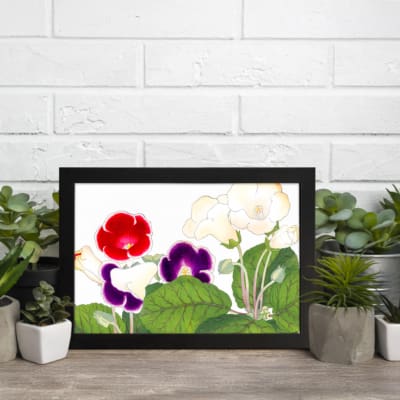 Vintage floral wall art with red, purple, and soft white flowers, framed in black for a stylish and elegant look. displayed on the wall