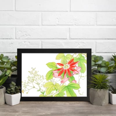 Infidu Vintage Floral Wall Art with a bright red flower, pink buds, green leaves, and small white flowers on a white background with a black frame. displayed on the wall