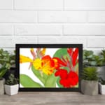 Vintage floral wall art with bright yellow and red flowers, green leaves, and a white background in a classic design. displayed on the wall