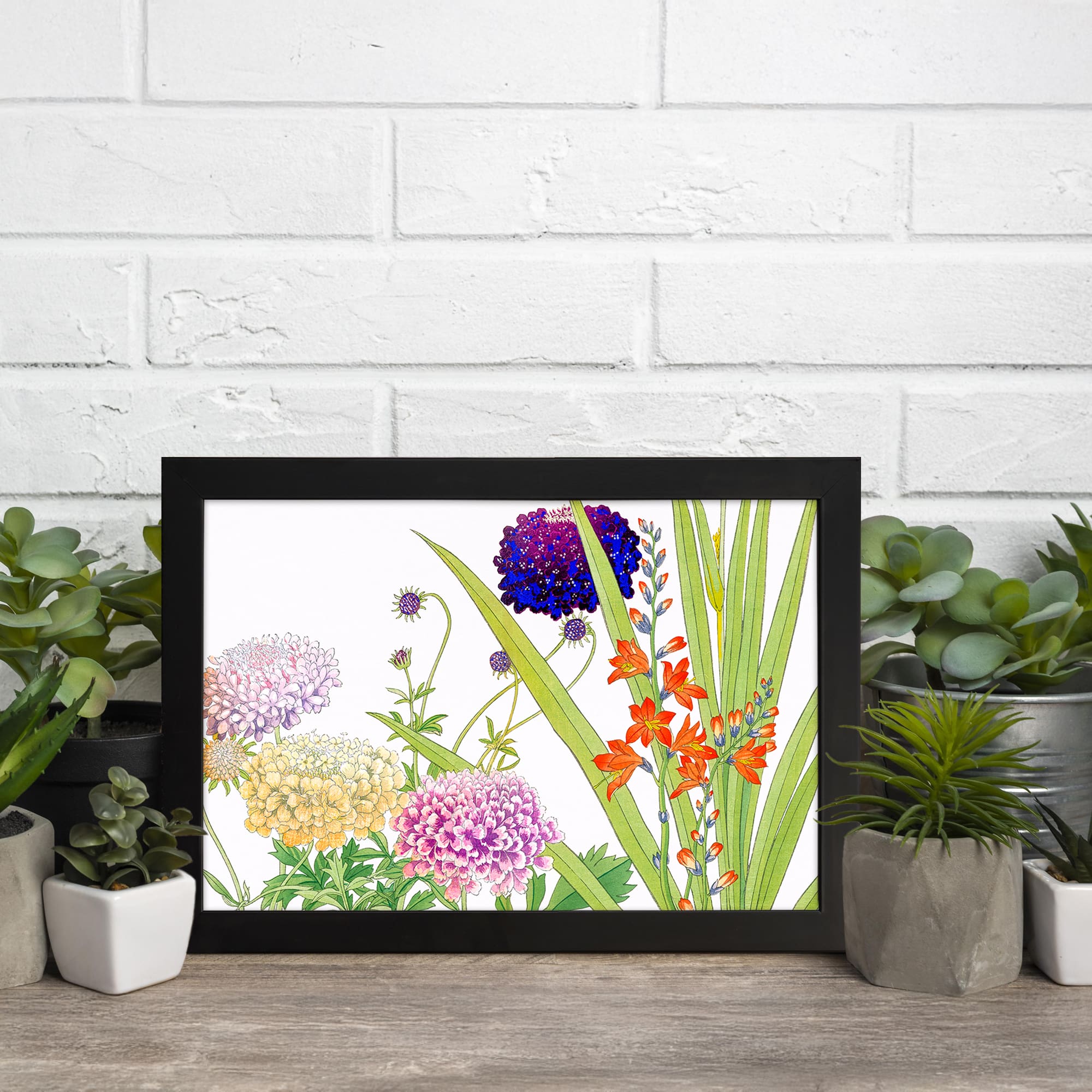 Vintage floral wall art featuring multicolor flowers in purple, pink, yellow, and orange with green leaves, set against a white background in a black frame. displayed on the wall.