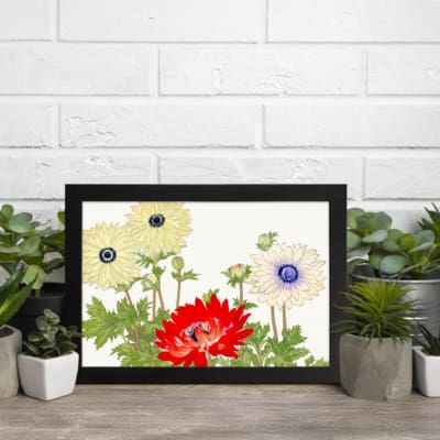 Vintage floral wall art with cream and red flowers, green leaves, and a white background in a classic design. displayed on the wall in a black frame