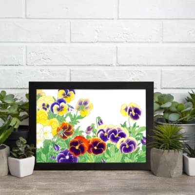 Infidu vintage wall art with colorful pansy flowers in shades of purple, yellow, and red, along with green leaves, framed in black on a white background. displayed on the wall