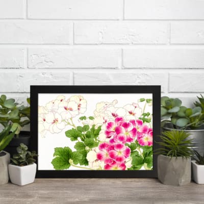 Infidu vintage wall art with pink and white flowers, green leaves, and a black frame on a white background for a timeless and elegant look. displayed on the wall in a black frame