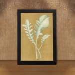 Vintage wall art of pale botanical fronds on an ochre background with a black frame. displayed on the wall in a black frame