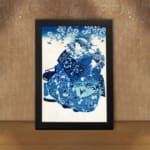 Infidu vintage wall art featuring a graceful figure in a patterned kimono with floral details, set against a soft cherry blossom background in a classic blue and white color scheme. displayed on the wall art in a black frame