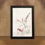 Vintage wall art with a bird surrounded by delicate flowers and plants in soft greens, reds, and whites, framed in black. displayed on the wall