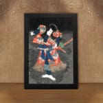 Japanese figure in bold red and blue kimono striking a dramatic pose against a dark vintage-style background. displayed on the wall in a black frame