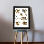 Vintage wall art with detailed ram illustrations in brown, beige, and black, set against a white background, resembling antique natural history prints. displayed on the table