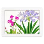 Infidu Vintage Floral Wall Art with soft purple and bright pink flowers, green leaves, a white background, and a white frame for a stylish touch. hung on the wall