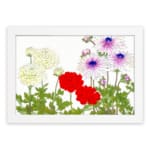 Vintage floral wall art with yellow, red, and purple flowers and green leaves on a white background. hung on the wall.